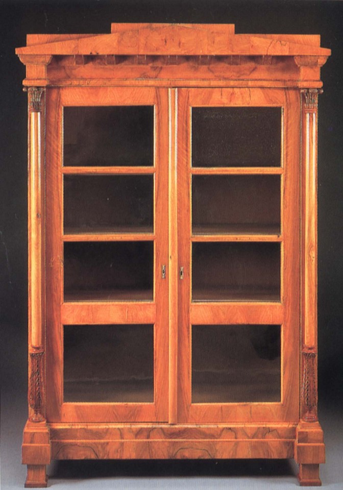 19th Century AUSTRIAN ,   Biedermeier Black Walnut Bookcase  ,  1800-1825  
  Walnut ,  78 x 51 5/8 x 20 1/2 in. (198.1 x 131.1 x 52.1 cm)  
  Peaked pediment and dentiled dornice above a pair of glazed cupboard doors opening to shelves flanked by collumnar supportw with acanthus-carved capitals and terminal raised on block feet  
  BIE-004-FU  
   Appraisal Value : $0.00 
 Location : $0.00 
 User3 : $0.00